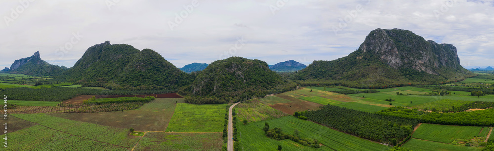 Aerial view Drone Panorama. Mountain and corn field in Rainy season. Agriculture and beautiful nature.