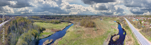 river between spring forest and meadow aerial view