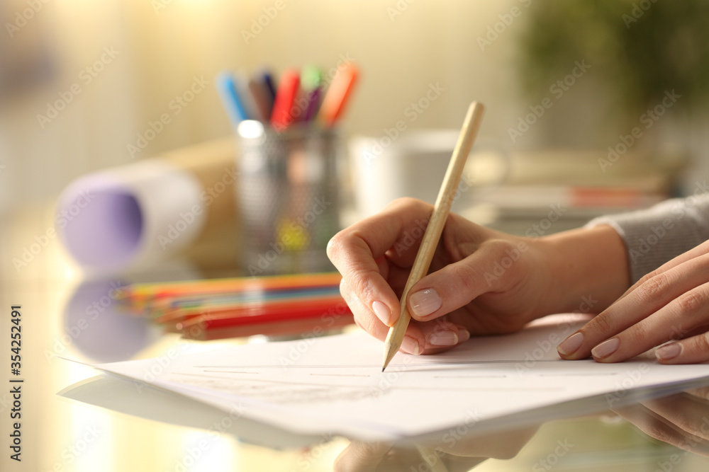 Designer woman sketching drawing with pencil on desk Designer woman sketching drawing with pencil on desk