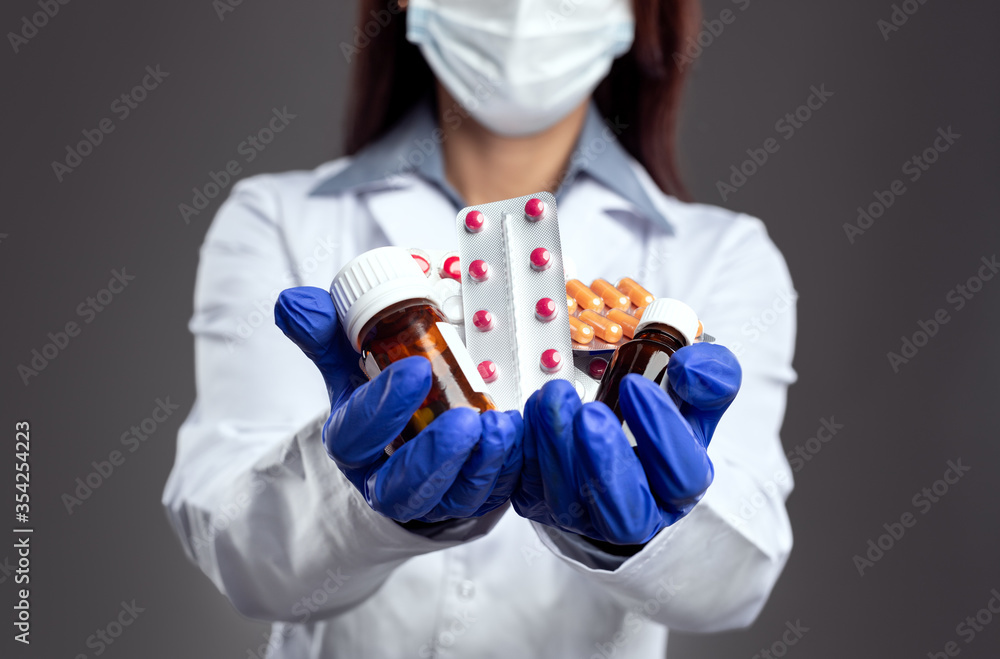 Female doctor with pile of drugs in hands Female doctor with pile of drugs in hands