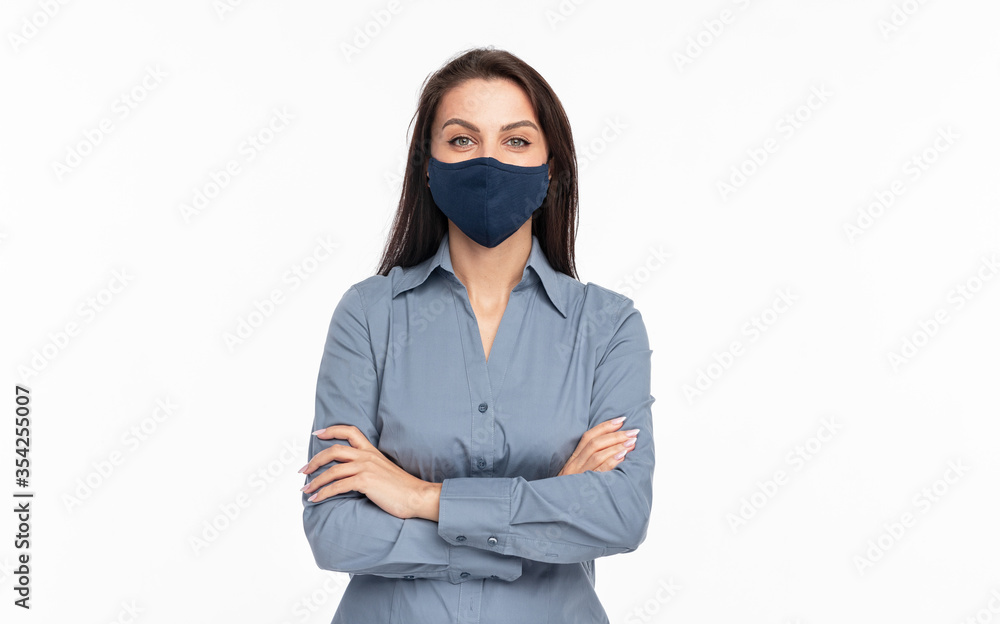 Confident young woman in protective mask looking at camera Confident young woman in protective mask looking at camera
