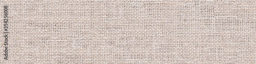 Linen canvas background in gentle light color for your new interior look. Seamless panoramic texture.