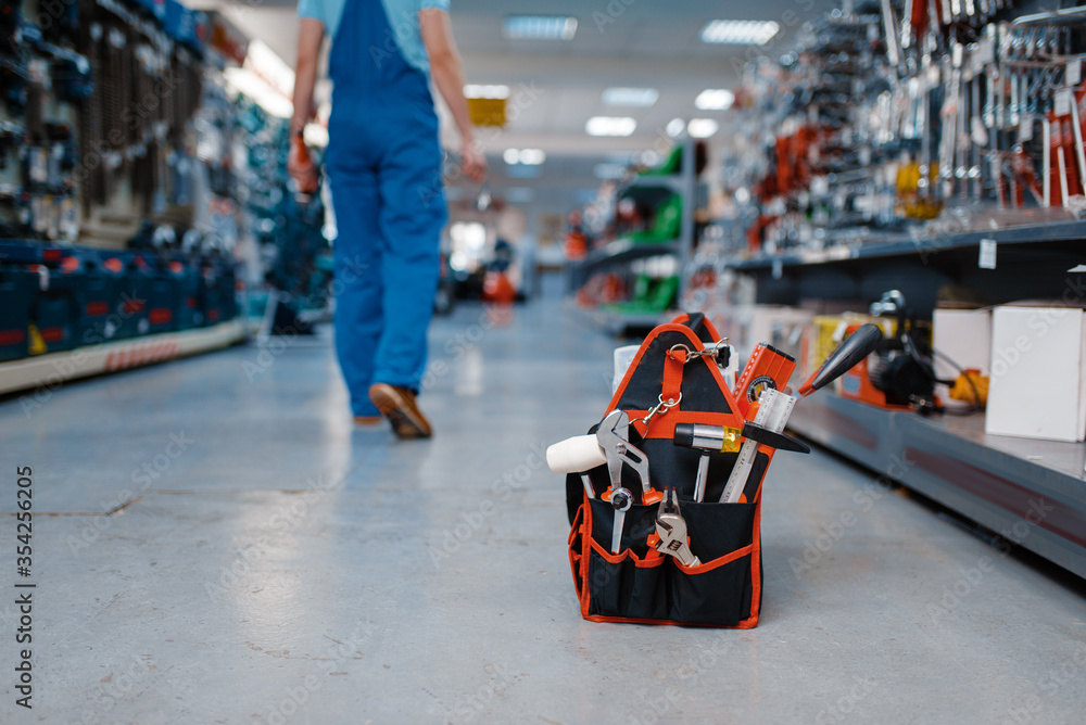 © Nomad_Soul - Toolbox in tool store, worker on background