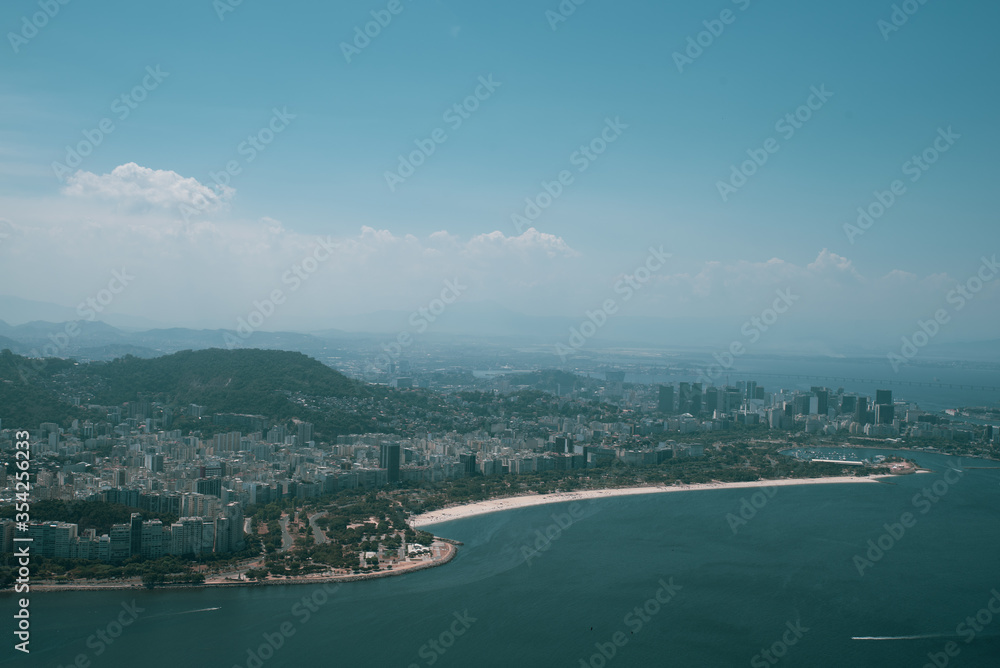 View of the Sugar Loaf in Botafogo, a mountain, and a landscape of Rio de Janeiro from a cable car, Brazil. View of the Sugar Loaf in Botafogo, a mountain, and a landscape of Rio de Janeiro from a cable car, Brazil.