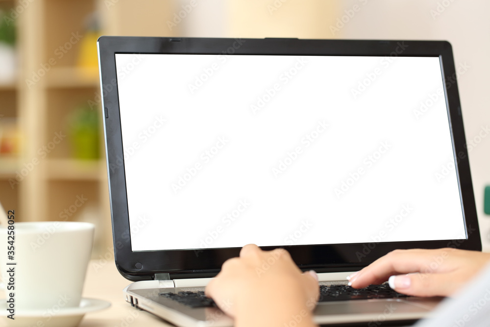 Woman hands using laptop with blank screen at home Woman hands using laptop with blank screen at home