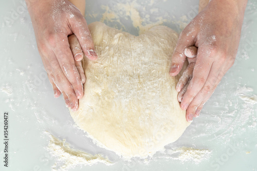 dad's and baby's hands form a heart-shaped yeast dough. concept of love and family values