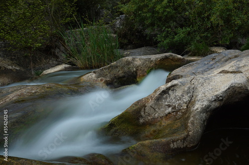 water flows between the rocks. long exposure river flowing between rocks.