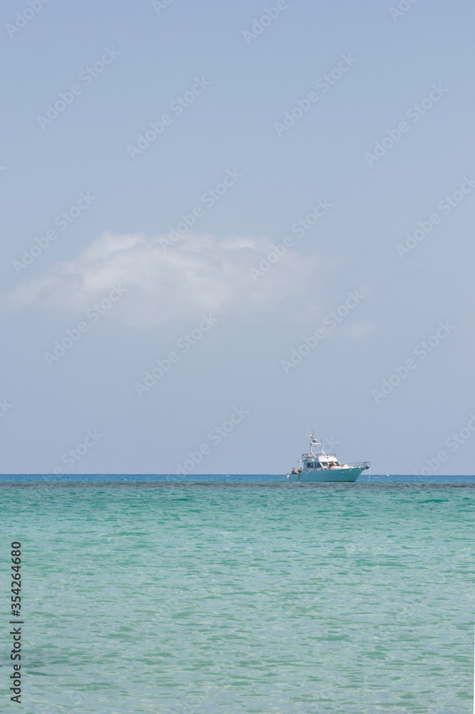 Seascape with a calm sea, a dive boat and blue sky looking from the Isla Los Lobos . Space left for copy text