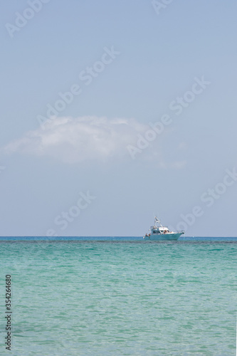 Seascape with a calm sea, a dive boat and blue sky looking from the Isla Los Lobos . Space left for copy text