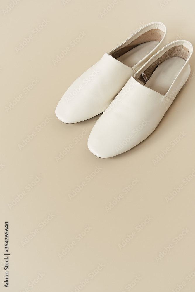 Fashion collage with women's white leather slippers on neutral beige. Minimal lifestyle concept. Fashion collage with women's white leather slippers on neutral beige. Minimal lifestyle concept.
