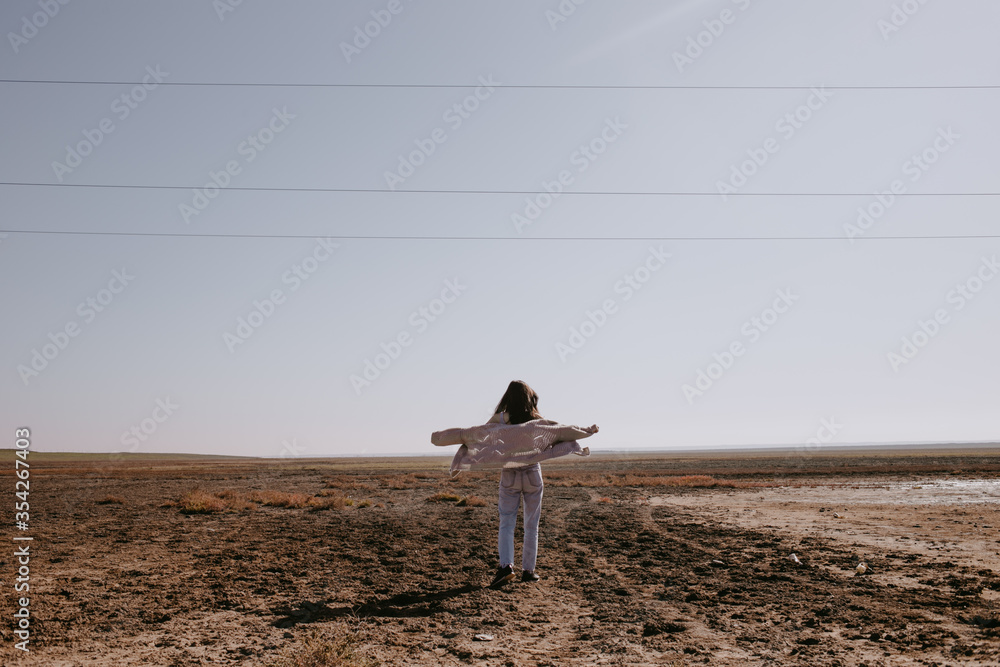 Obraz premium the woman in empty steppe field