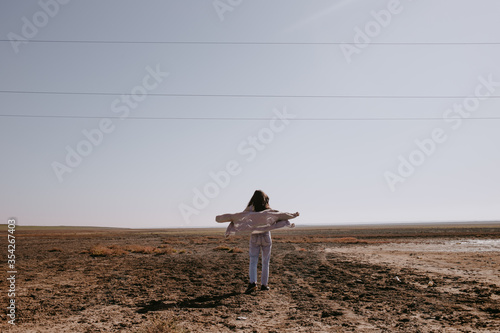the woman in empty steppe field