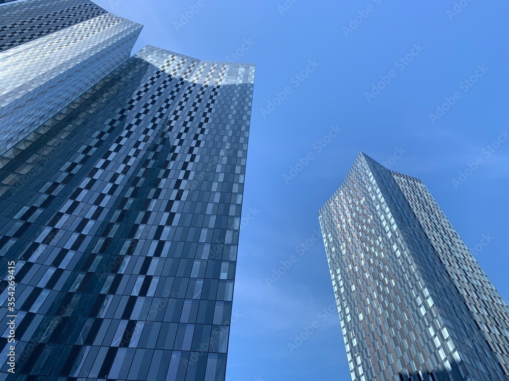 Looking up at a modern skyscraper with a clear blue sky background. Taken in Manchester England. 