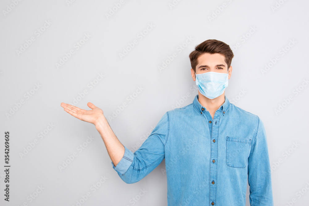 Portrait of handsome young successful businessman in blue shirt wear medical safety face mask , corona virus prevention protection concept, guy showing way or medicine product with hand and pointing Portrait of handsome young successful businessman in blue shirt wear medical safety face mask , corona virus prevention protection concept, guy showing way or medicine product with hand and pointing