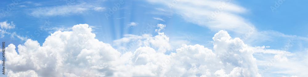 In sunny summer, huge clouds float on the blue sky. In sunny summer, huge clouds float on the blue sky.