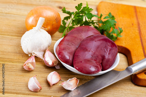 Raw pork kidneys with seasonings photo