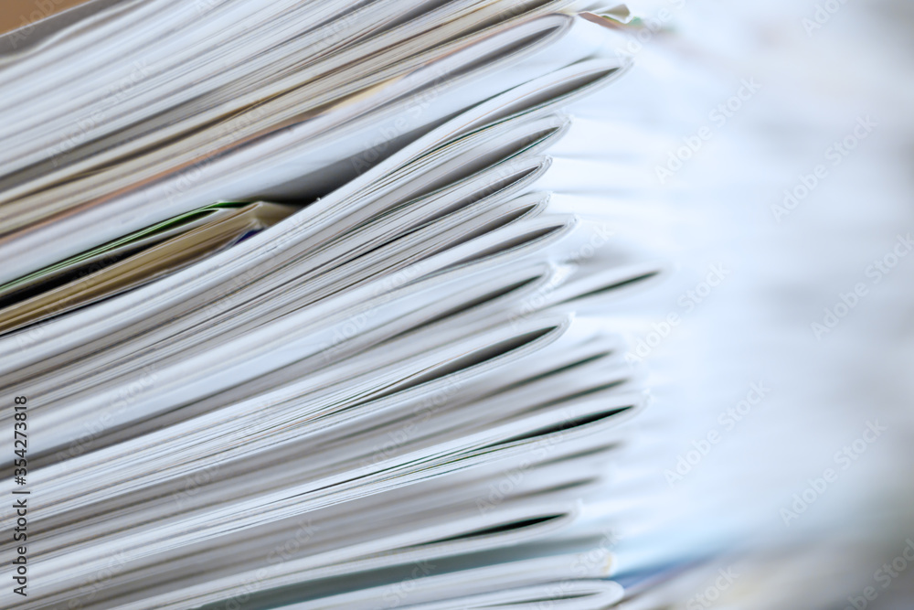 積み重さなった沢山の白い表紙の本