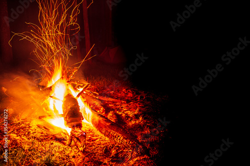 bonfire at night in the forest, sparks from a fire, Night campfire with available space