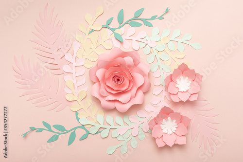 Paper art pink background with flowers and tropical leaves. Fashion floral gr...