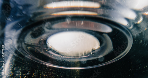 Abstract, ice ball sinking into water