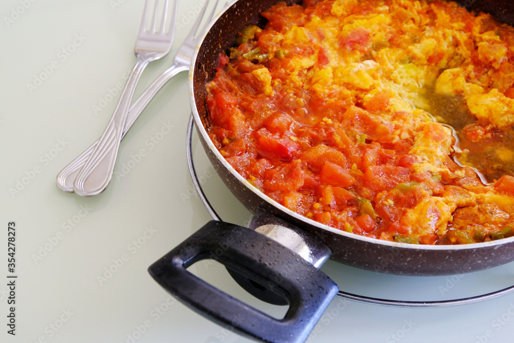 menemen dinner made with tomatoes and eggs in the pan for breakfast, menemen dinner made with tomatoes and eggs in the pan for breakfast,