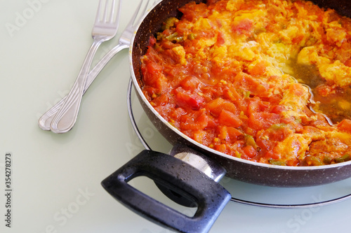 menemen dinner made with tomatoes and eggs in the pan for breakfast,