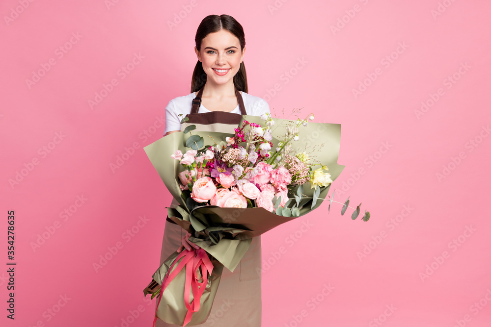 Portrait of her she nice attractive lovely pretty cheerful girl shop owner entrepreneur seller holding in hands bunch different flowers roses isolated over pink pastel color background Portrait of her she nice attractive lovely pretty cheerful girl shop owner entrepreneur seller holding in hands bunch different flowers roses isolated over pink pastel color background