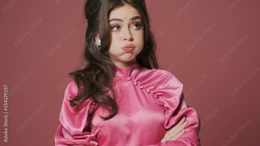 Young displeased negative woman isolated over pink wall background Young displeased negative woman isolated over pink wall background