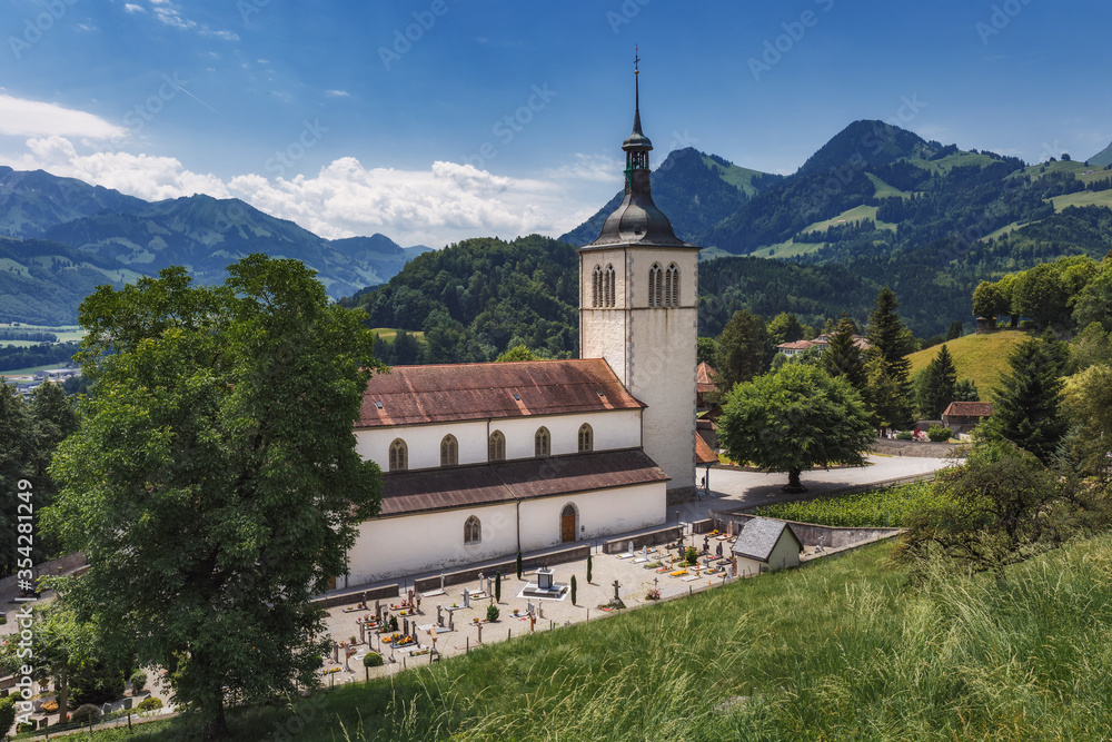 Fototapeta premium The Eglise Saint Theodule and Saane valley - Gruyeres, Switzerland