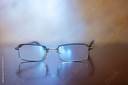 Reading glasses on a wooden table
