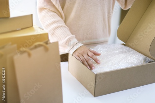Business From Home woman preparing package delivery box Shipping for shopping online. young start up small business owner at home online order shopping