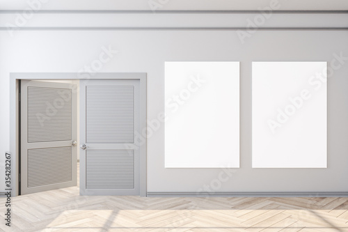 Clean home interior with door and two empty posters on wall.