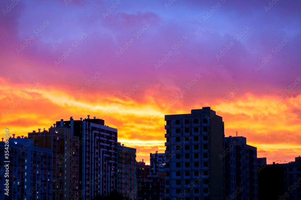 Sunset in the city. Fire, a beautiful sunset over the houses of the city. Fire sky.