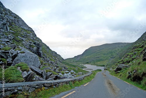 Road through the landscape with a lake in the background, Ireland