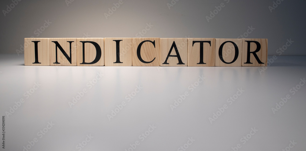 Indicator word from wooden blocks. Business and banking concept. Spot light on white background. Close up. Indicator word from wooden blocks. Business and banking concept. Spot light on white background. Close up.