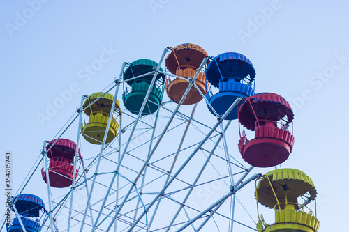 ferris wheel on a blue sky, colored ferris wheel in the park