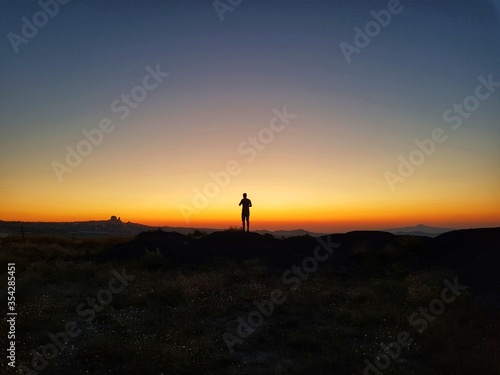 Silhouette of a man standing on a hill, Silhouette of a man on the sunset, Cappadocia, Kapadokya, Turkey, Uchisar Castle in Cappadocia Region of Turkey, Sunset, National Geographic