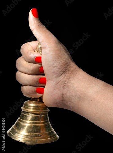 Hand held puja bell With Black Background for Indian bengali rituals for Ganesh Puja, durga puja, kali puja, lakshmi, saraswati.