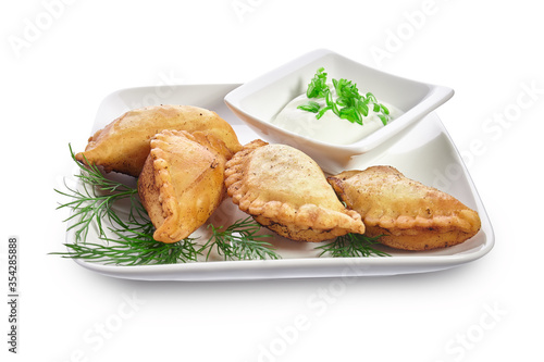 Chebureks on a white plate isolated on a white background