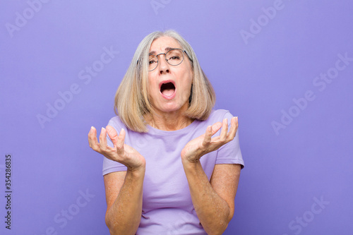 Obraz na plátně senior or middle age pretty woman looking desperate and frustrated, stressed, un