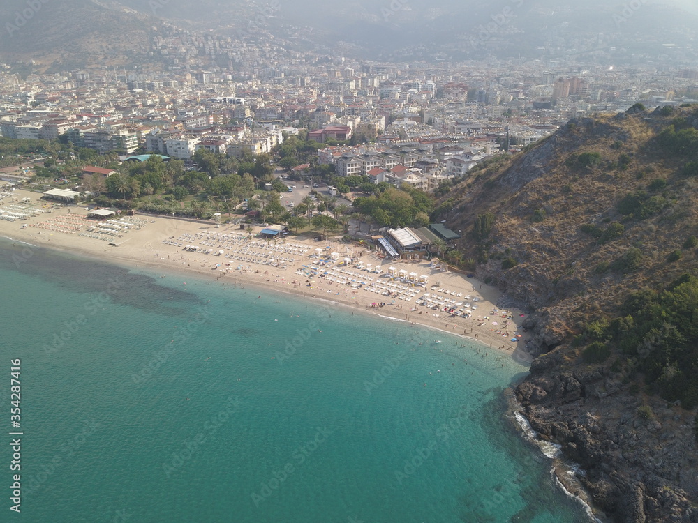 Aerial view of the coast of the sea in Alanya, view of the coast of the mediterranean sea, view of the beach, waves on the beach, turkey, alanya, kemer, travel around turkey, mountains