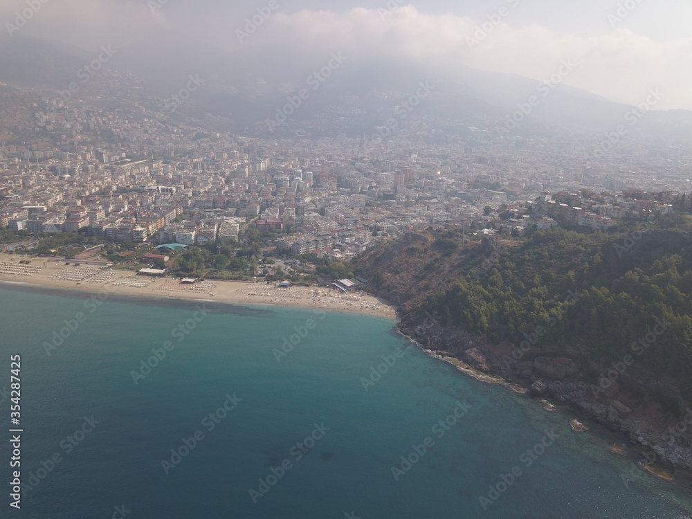 Aerial view of the coast of the sea in Alanya, view of the coast of the mediterranean sea, view of the beach, waves on the beach, turkey, alanya, kemer, travel around turkey, mountains