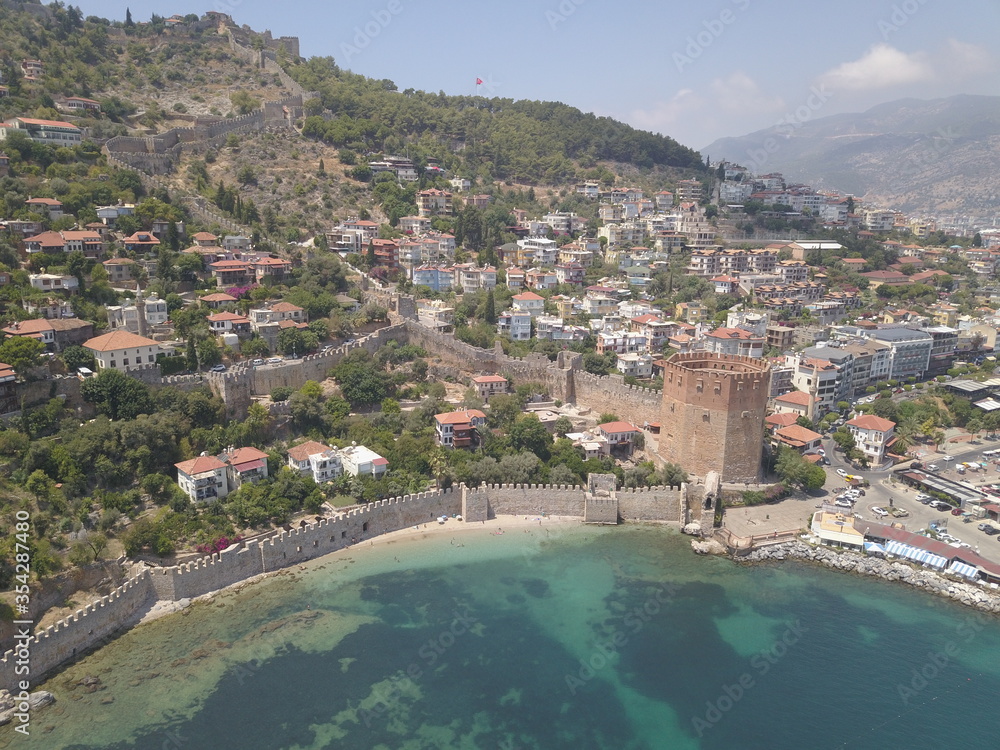 Aerial view of the coast of the sea in Alanya, view of the coast of the mediterranean sea, view of the beach, waves on the beach, turkey, alanya, kemer, travel around turkey, mountains, Red Tower 