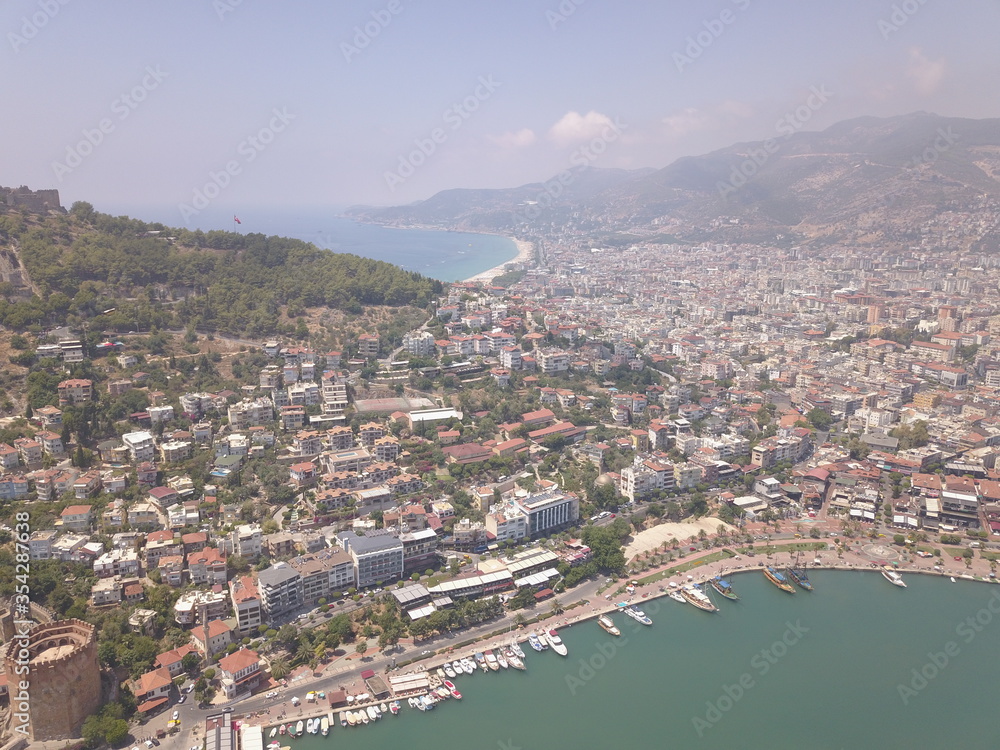 Aerial view of the port, the coast of the sea in Alanya, view of the coast of the mediterranean sea, view of the beach, waves on the beach, turkey, alanya, kemer, travel around turkey, lighthouse