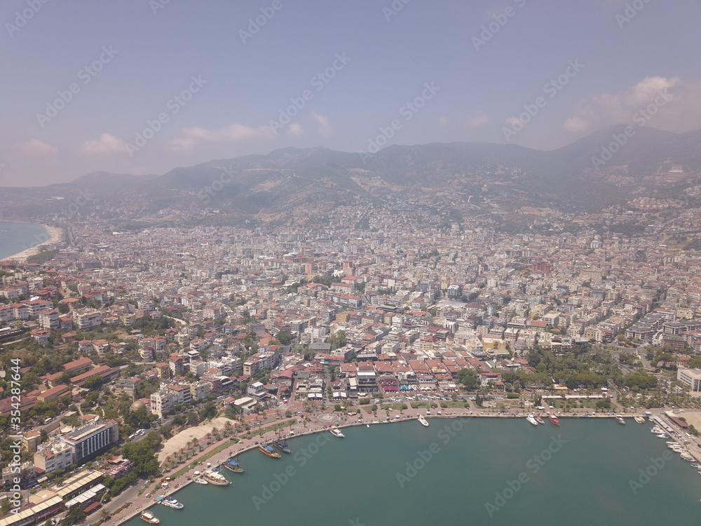 Aerial view of the port, the coast of the sea in Alanya, view of the coast of the mediterranean sea, view of the beach, waves on the beach, turkey, alanya, kemer, travel around turkey, lighthouse