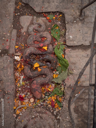 Patan, Kathmandu, Nepal. High angle close up of serpent guardian of hindu temple.