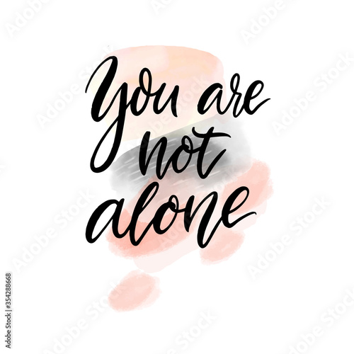You are not alone. Support quote. Inspirational saying, handwritten calligraphy text on abstract pink and gray watercolour stains.