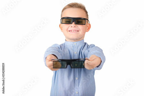 Excited young african american guy in 3d imax glasses posing isolated on yellow orange background in studio. People lifestyle concept. Mock up copy space. Watching movie film hold bucket of popcorn photo