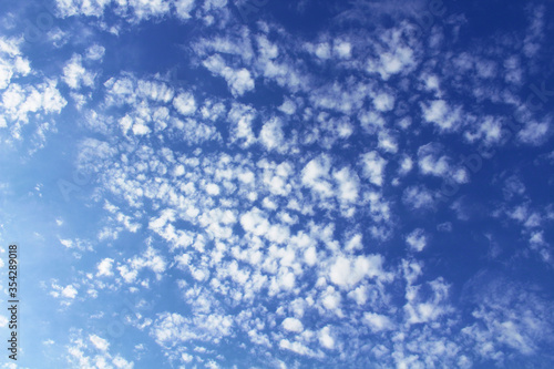 Beautiful blue sky and white cirrocumulus clouds. Background. Texture. Landscape.