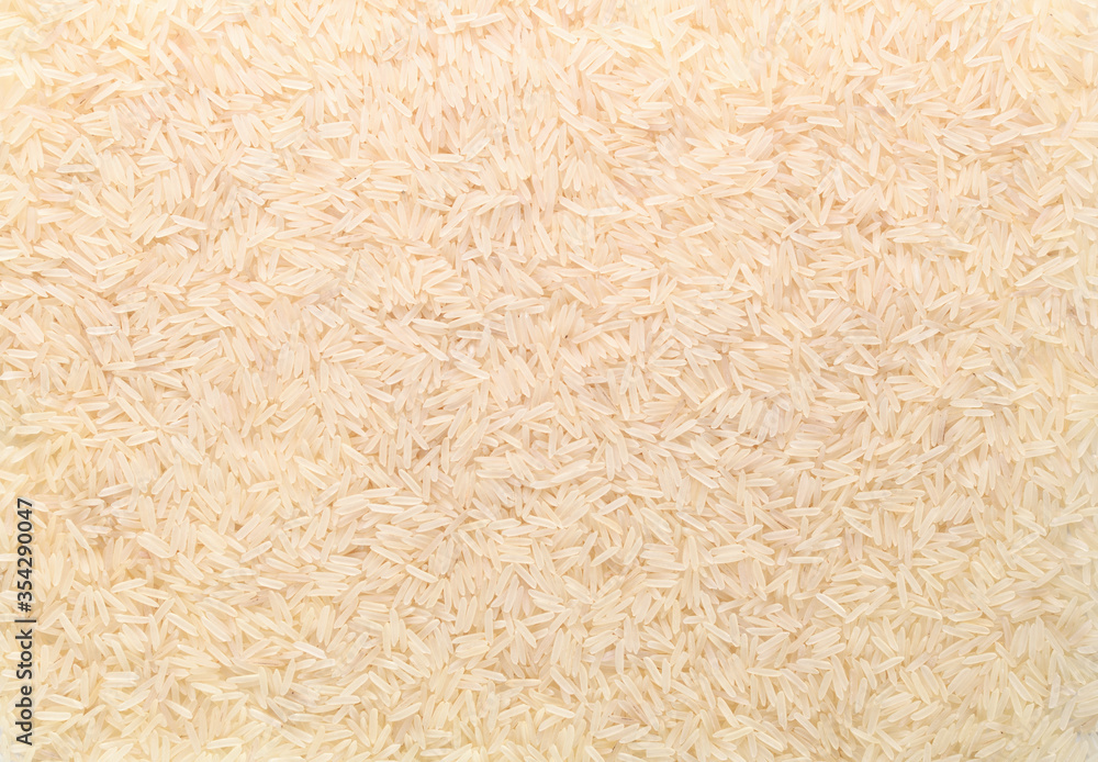 Basmati white rice solid texture. Top view close-up on raw rice grains. Healthy food concept Basmati white rice solid texture. Top view close-up on raw rice grains. Healthy food concept
